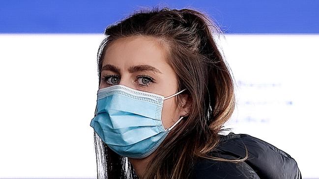 MELBOURNE, AUSTRALIA - NewsWire Photos 24 AUGUST 2021 : A young woman lines up at the Melbourne Convention Exhibition Centre to get a Covid-19 vaccination. Picture : NCA NewsWire / Ian Currie