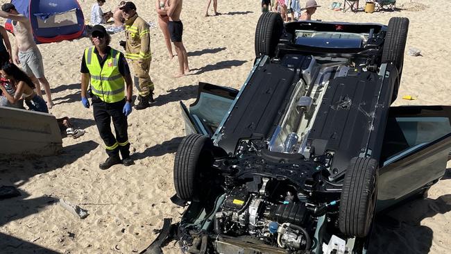 Emergency services are responding to an active incident after a car reportedly crashed through a concrete barrier and flipped onto Balmoral Beach. Picture: NCA NewsWire