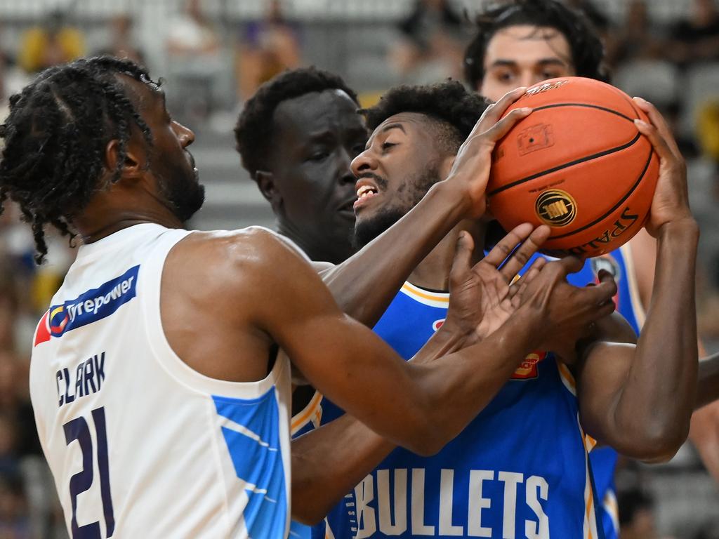 Keandre Cook from the Bullets is wrapped up by Melbourne United defenders. Picture: Getty Images