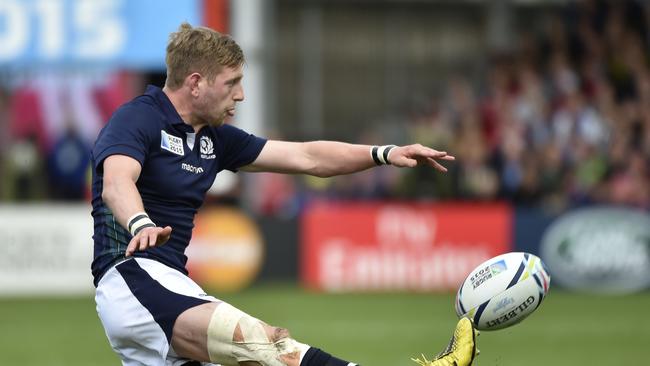 Scotland's fly half Finn Russell clears the ball.