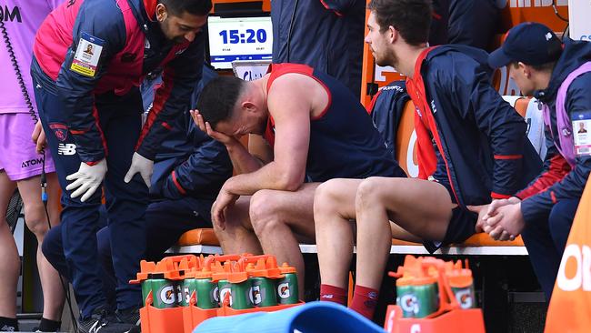 Steven May of the Demons sits on the bench after injuring his hamstring