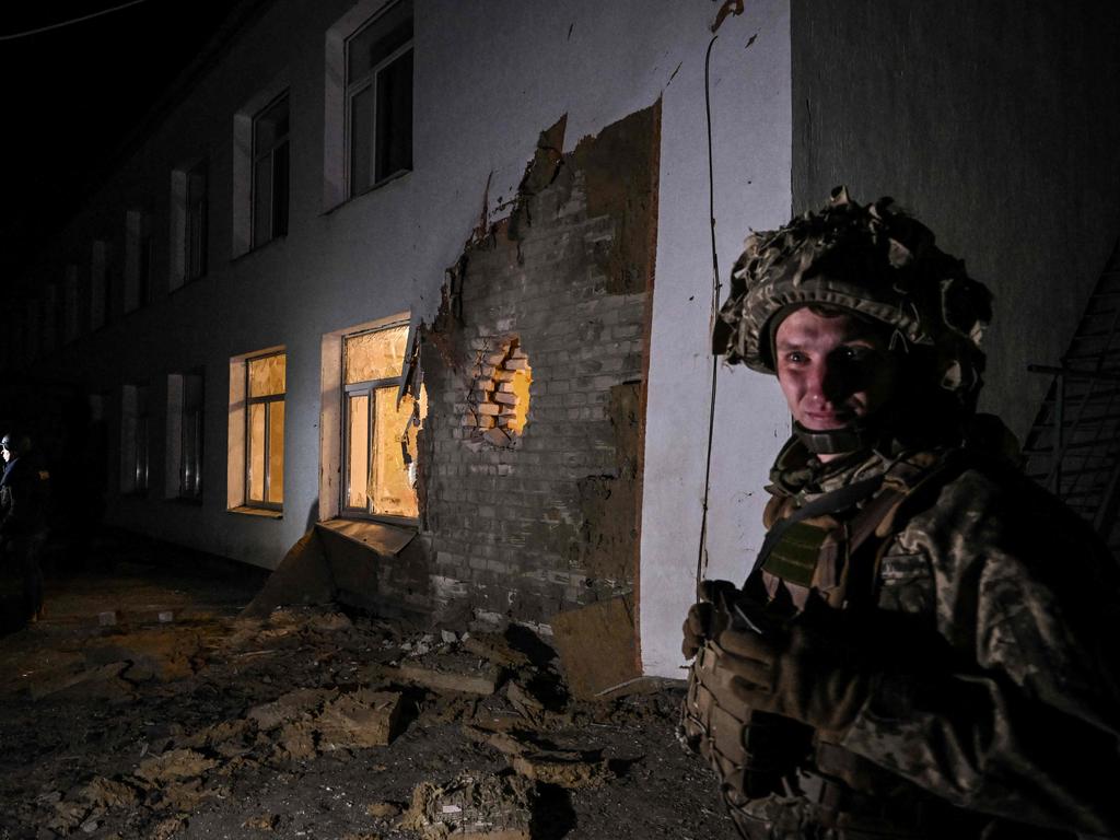 An Ukrainian soldier stands guard after the reported shelling of a kindergarten. Picture: Aris Messinis/AFP