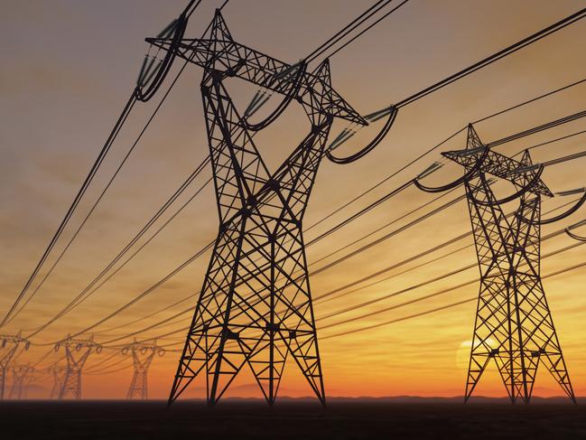 The silhouette of the high voltage power lines during sunset.