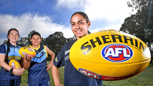 Chloe Marquis and Geremy with AFLW player Courtney Hodder at Mabel Park State High School. . Picture, John Gass