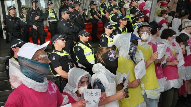 Paint-soaked protesters at IMARC demonstrations. Picture: AAP Image/David Crosling