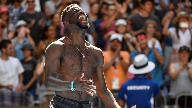 TOPSHOT - Frances Tiafoe of the US celebrates his victory against Bulgaria's Grigor Dimitrov afteer winning their men's singles match on day seven of the Australian Open tennis tournament in Melbourne on January 20, 2019. (Photo by Paul Crock / AFP) / -- IMAGE RESTRICTED TO EDITORIAL USE - STRICTLY NO COMMERCIAL USE --