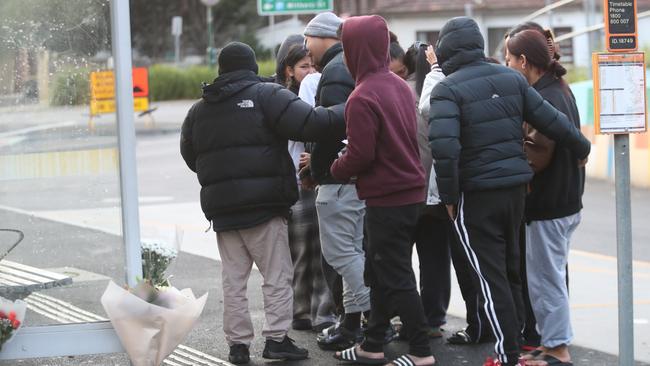 Family and friends gather at the scene on Friday morning. Picture: David Crosling