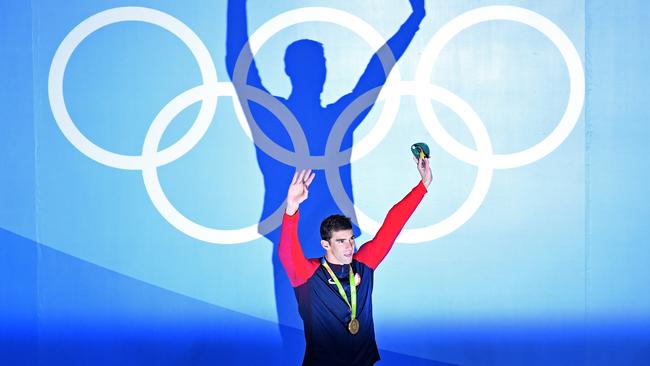 RIO DE JANEIRO, BRAZIL - AUGUST 09: Gold medalist Michael Phelps of the United States celebrates on the podium during the medal ceremony for the Men's 200m Butterfly Final on Day 4 of the Rio 2016 Olympic Games at the Olympic Aquatics Stadium on August 9, 2016 in Rio de Janeiro, Brazil. (Photo by Richard Heathcote/Getty Images) *** BESTPIX ***