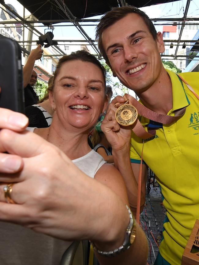 Race walk gold medalist Dane Bird-Smith poses for a selfie with a fan. Picture: Dan Peled/AAP