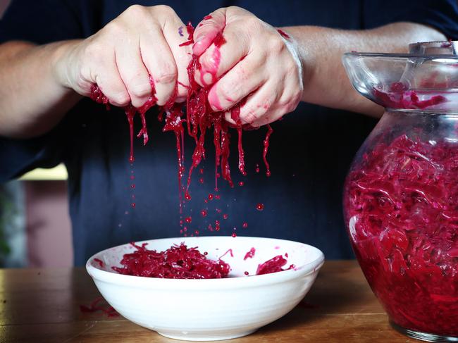 Sharon Flynn squeezes the juice from the fermented cabbage. Picture: Rebecca Michael