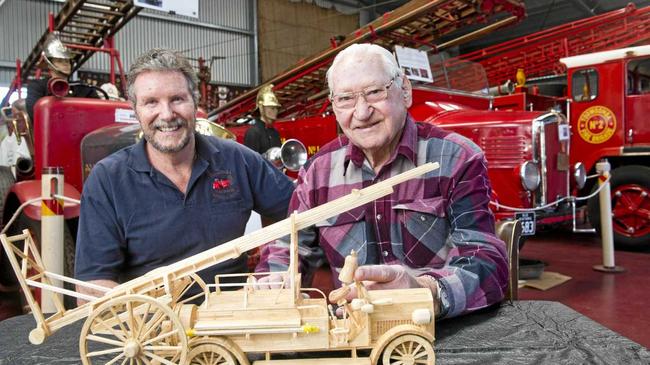 SPECIAL GIFT: Inspecting the match stick model of an early 1900s Ford fire engine are Toowoomba Fire Brigade Museum's Pieter de Kroon and maker Ian Walker. Picture: Nev Madsen