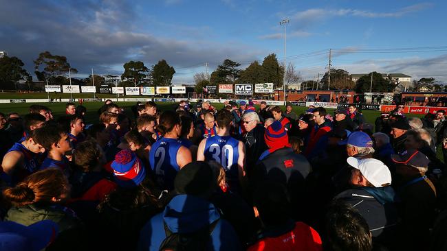 Port Melbourne supporters gather at the huddle to listen to coach Gary Ayres.