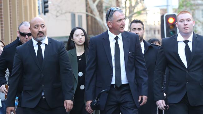 Chinese actress Xuan Dong (centre) walks within a phalanx of security on her way to court. Picture: Richard Dobson