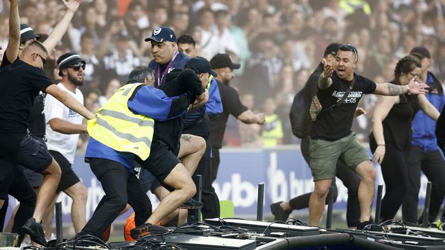 MELBOURNE, AUSTRALIA - DECEMBER 17: Fans storm the pitch in protest during the round eight A-League Men's match between Melbourne City and Melbourne Victory at AAMI Park, on December 17, 2022, in Melbourne, Australia. (Photo by Darrian Traynor/Getty Images)