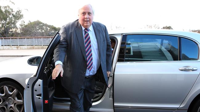 Clive Palmer arriving at the House of Representatives doors at Parliament House in Canberra.