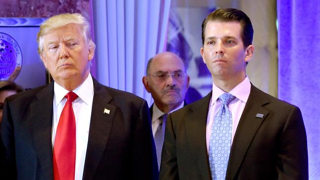 Donald Trump along with his son Donald, Jr. at Trump Tower in New York, as Allen Weisselberg (C), chief financial officer of Trump’s company, looks on.