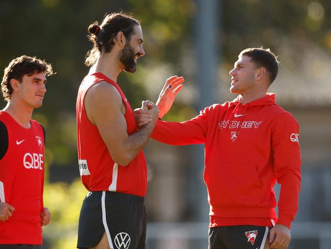 Former Collingwood teammates Brodie Grundy and Taylor Adams share a moment at training. Picture: Michael Willson/AFL Photos via Getty Images.