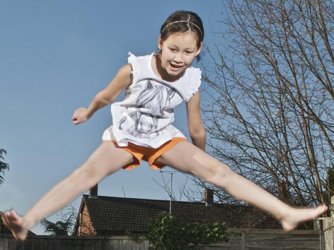 Girls jumping together on trampoline