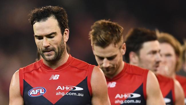 Dejected Melbourne players leave the field. Picture: Getty Images