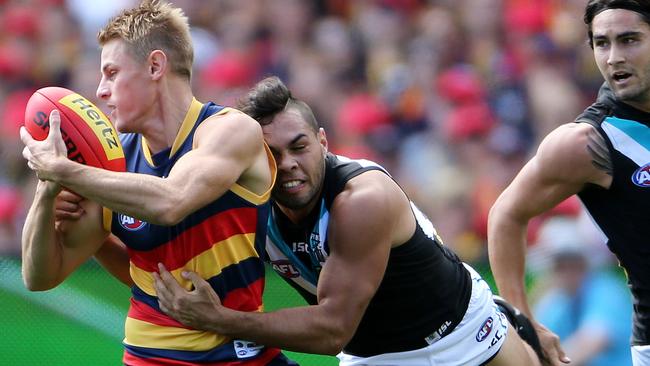 Adelaide’s David Mackay tackled by Port Adelaide’s Jarman Impey during Showdown 40.