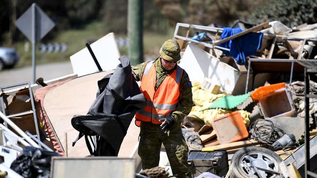 Members of the Australian Defence Force help with the clean-up of flood-affected properties in Goodna, west of Brisbane. Picture: Dan Peled