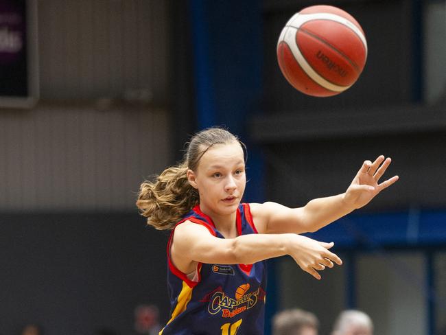 Brisbane Capitals Anna Bassett fires a pass across the key during last year’s Basketball Queensland Under-16 State Championships. Picture: Renae Droop