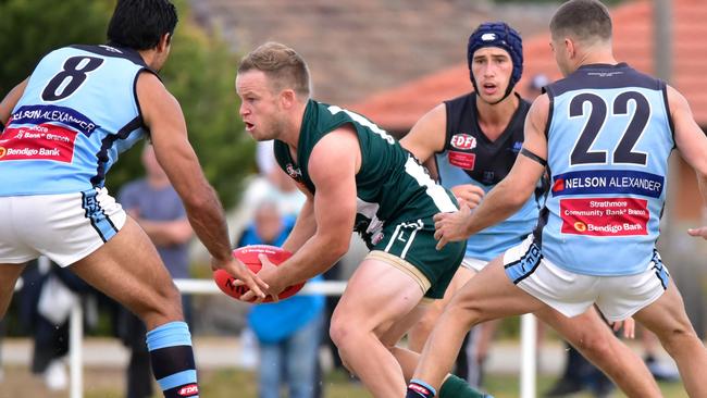 Airport West's Daniel Sinnott tries to find a way through heavy traffic. Picture: Jamie Morey