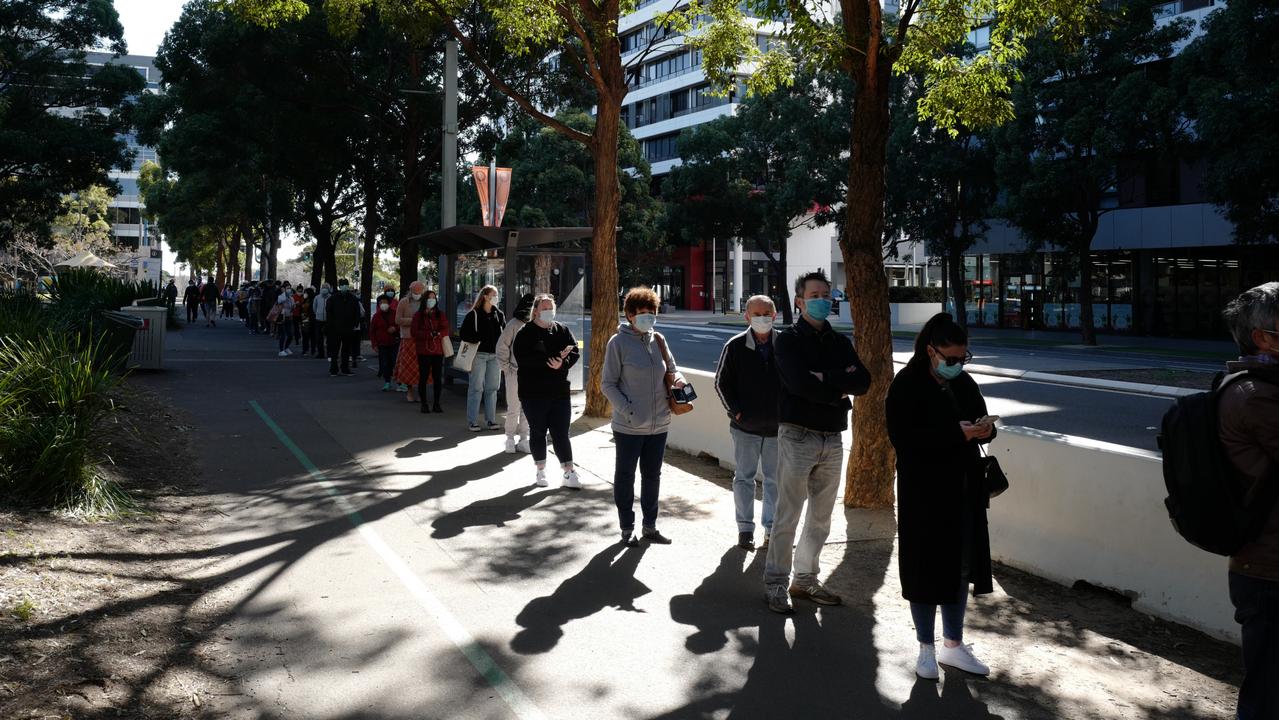 A long queue of people wait to get a vaccine at a mass jab clinic in Sydney. Picture: Getty Images