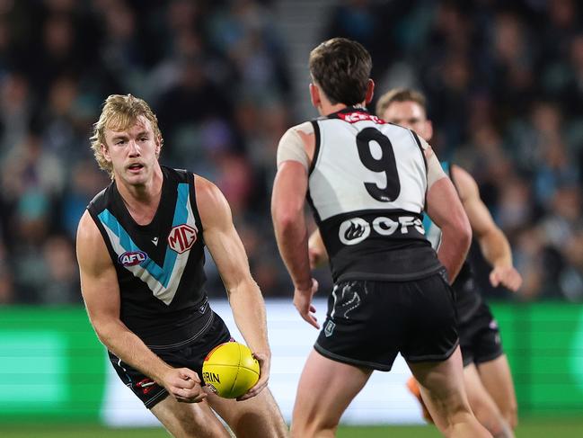 Jason Horne-Francis handpasses to Zak Butters on Sunday. Both players were below their best as the Giants overran the Power. Picture: Sarah Reed/AFL Photos via Getty Images.