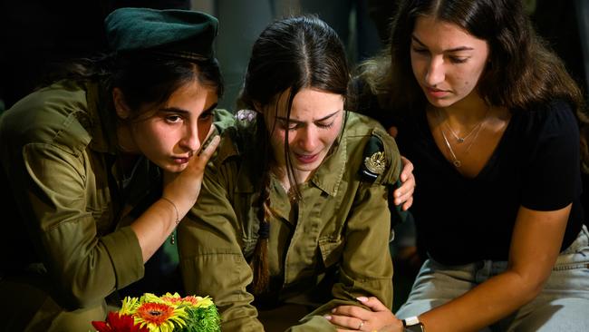 Family and friends of Captain Eitan Oster — killed in this week’s fighting against Hezbollah — gather at his graveside following his funeral at Mount Hertzl military cemetery this week. Picture: Getty Images