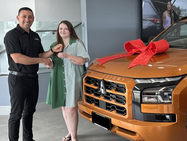 SuperCoach NBL winner Charlotte Phillips with her prize, a 2024 Mitsubishi Triton GSR 4x4 Double Cab Pick-Up.