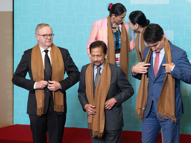 Canada's Prime Minster Justin Trudeau (R), Australian Prime Minister Anthony Albanese (L) and Sultan of Brunei Haji Hassanal Bolkiah (C) participate in a family photo during the Asia-Pacific Economic Cooperation (APEC) Leadersâ Retreat summit in Lima, Peru, November 16, 2024. (Photo by SAUL LOEB / AFP)