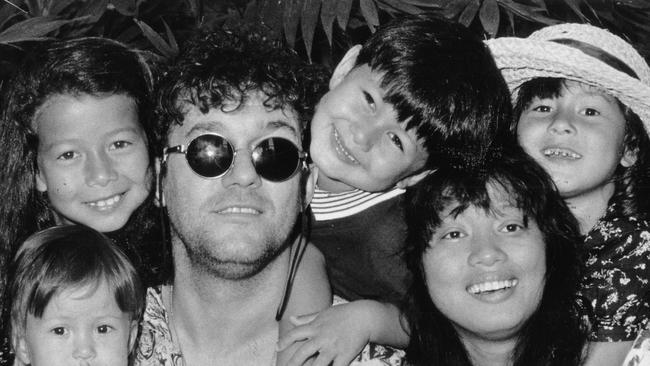 A doting Dad lurks behind the Wildman image of rocker Jimmy Barnes. His wife Jane and their children joined him at a press conference and Barnes's smiled as the children dominated the event with giggling, chair-climbing and ice-throwing. Published: 29/9/1990. Page 35.