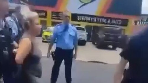 Helen Mary Delaney being arrested near the Pacific Highway in Coffs Harbour.