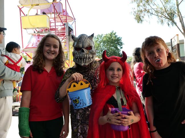 Finn, August, Clementine and Fred in front of the rides at the Greythorn Halloween festival.