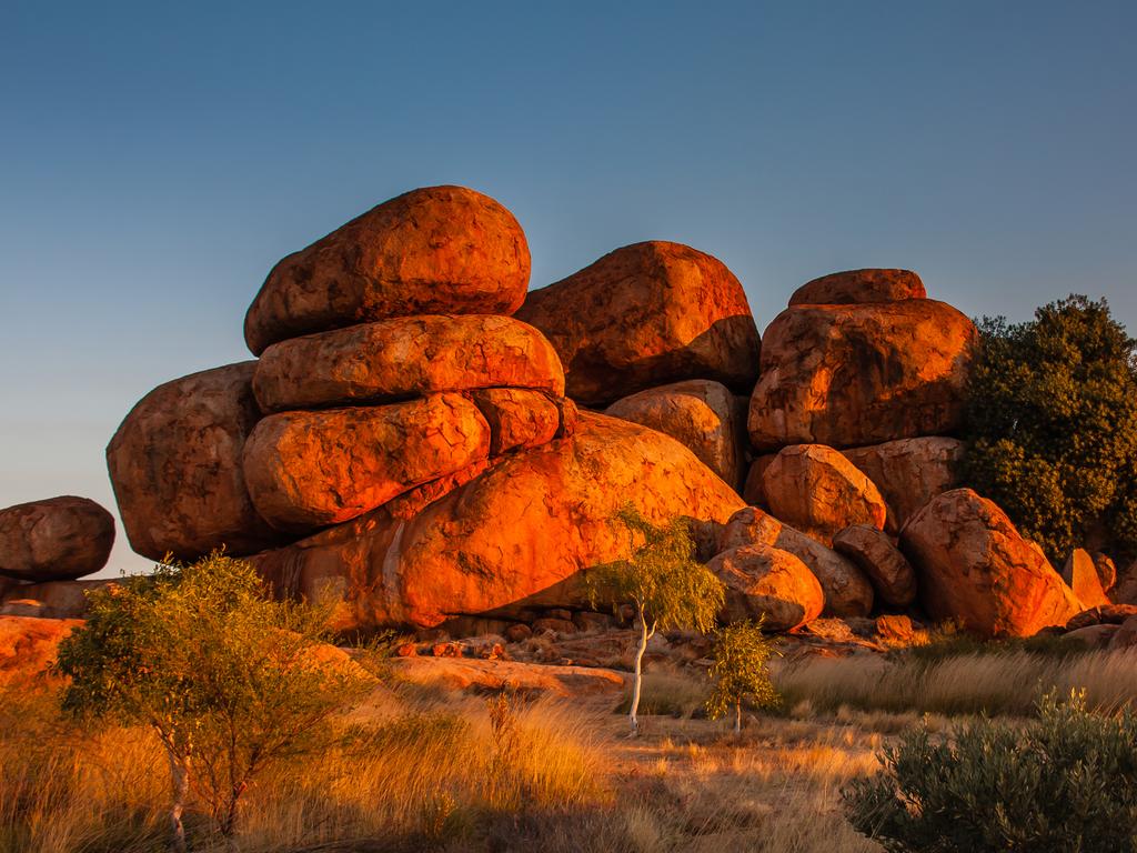 <span>15/50</span><h2>Devils Marbles, NT</h2><p>This collection of massive boulders strewn across the valley is a natural wonder steeped in ancient Aboriginal mythology that says these <a href="https://nt.gov.au/leisure/parks-reserves/find-a-park-to-visit/karlu-karlu-devils-marbles-conservation-reserve" target="_blank">Marbles</a> are the fossilised eggs of the Rainbow Serpent. Visit Tennant Creek and see these six-metre high rock formations that are millions of years old and learn about the Dreaming stories that surround this geological marvel.</p>