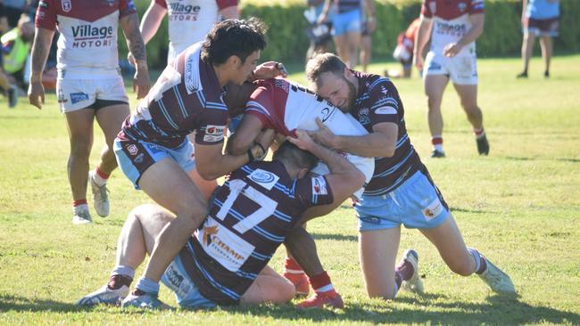 The Capras muscle up in defence against the Redcliffe Dolphins at Rugby Park on Sunday.