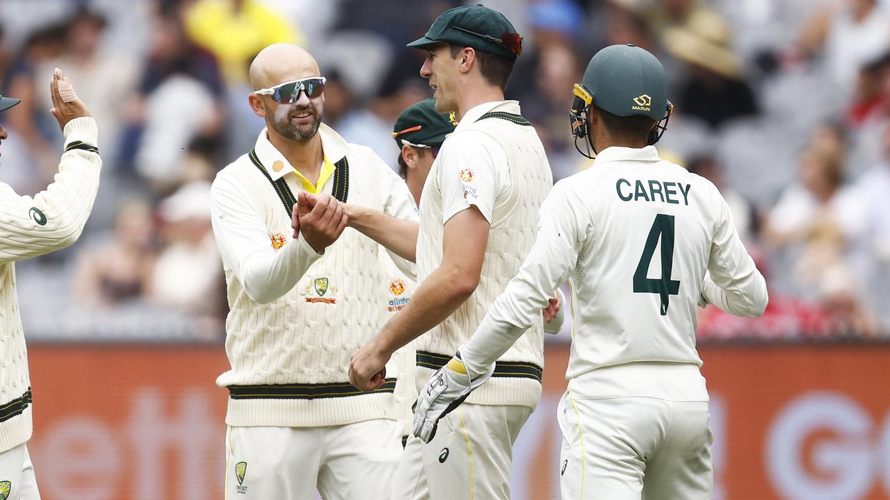 MELBOURNE, AUSTRALIA - DECEMBER 29: Nathan Lyon of Australia (C) celebrates with Pat Cummins of Australia after combining to dismiss Kagiso Rabada of South Africa during day four of the Second Test match in the series between Australia and South Africa at Melbourne Cricket Ground on December 29, 2022 in Melbourne, Australia. (Photo by Daniel Pockett/Getty Images)