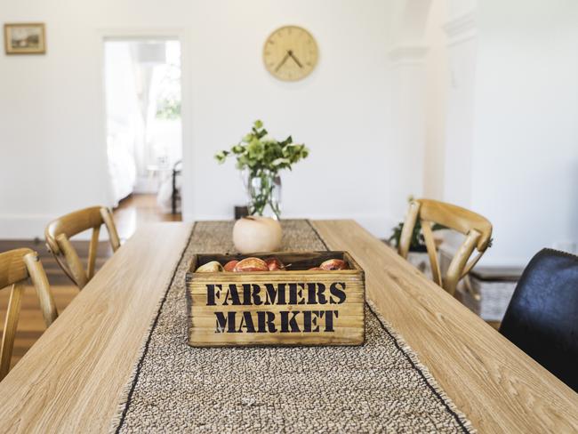 The cottage’s dining table with box of fresh pink lady apples sourced from nearby Lucaston orchard. Picture: Joe Chelkowski