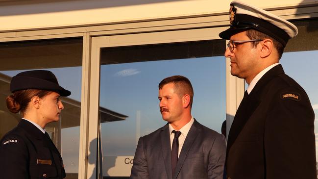 Luke MacMaster, centre, speaks to his lawyers outside the Defence Force Magistrates Court last month. Picture: Blake Foden