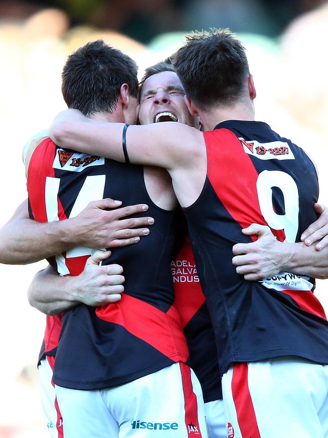 Shannon Green screams as the final siren sounds in the Bloods’ 2015 grand final win – being hugged by Jonathon Beech and Aaron Fielke. Picture: Sarah Reed.