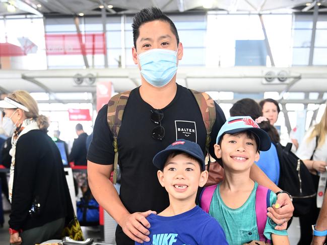 Colin Tran with sons, Levi, 6, and Mason, 9, who were flying to Brisbane from T2 Domestic Sydney airport. Picture: Jeremy Piper