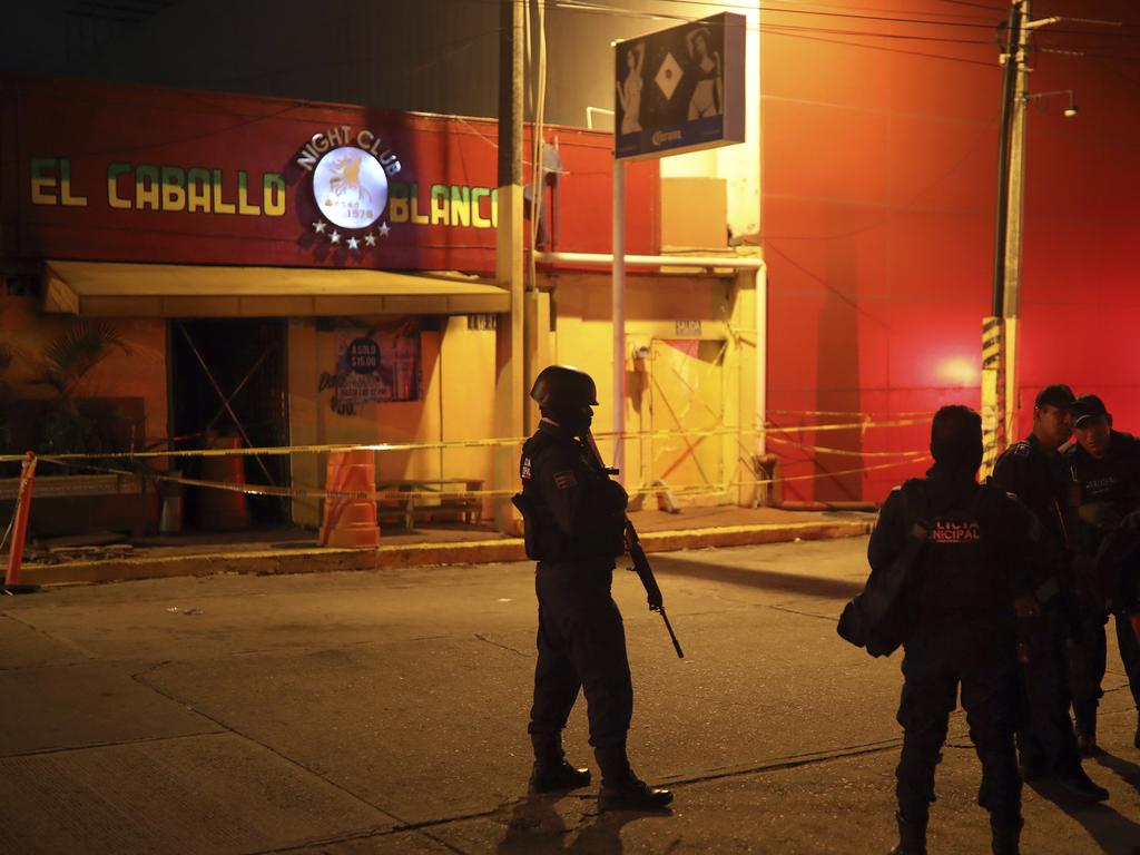 Police officers guard the scene outside a bar where more than 20 people died in an overnight attack, in Coatzacoalcos, Mexico. Picture: AP