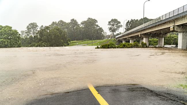 The effects from the Hinze Dam's spilling overflow seen as rising flood waters consume the lower causeway at Weedon's Crossing in Nerang. Photo: Luke Sorensen – Coral Sea Media