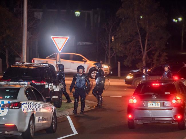 Dozens of police some in riot gear gather near Lonzo Park in Taylors Hill . Police also  blocked off part of Gourlay road. Picture: Jason Edwards