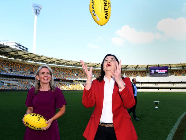 Premier Annastacia Palaszczuk tosses a Sherrin while Tourism Minister Kate Jones looks on. Picture: Dan Peled/NCA NewsWire