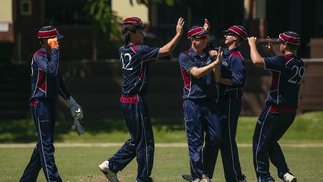 TSS First 11 celebrate the opening wicket from quick Ellis McCarthy of BSHS’s Adam Eastgate as the Southport School v Brisbane State High School at The Southport School/Village Green. Picture: Glenn Campbell