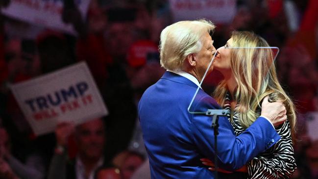 Donald Trump kisses Melania Trump on stage at the rally. Picture: AFP.