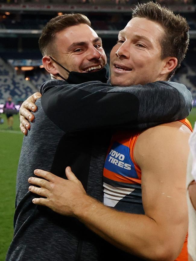 Stephen Coniglio and Toby Greene embrace.