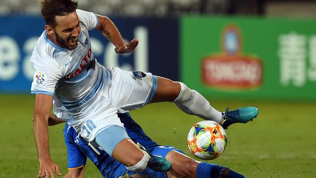 Sydney FC’s Milos Ninkovic is tackled against Usain Hyundai’s on Wednesday night. Picture: AFP 